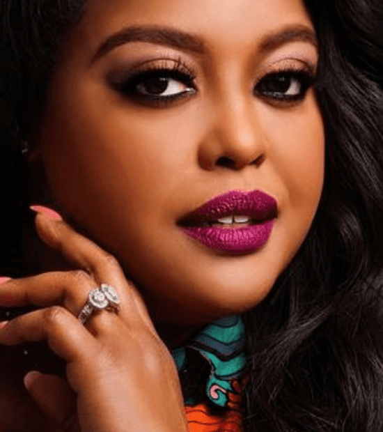 Woman with vibrant lipstick and elegant ring.